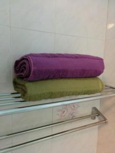 een stapel handdoeken op een plank bij Mary Apt @ Equatorial Hill Resort in Cameron Highlands