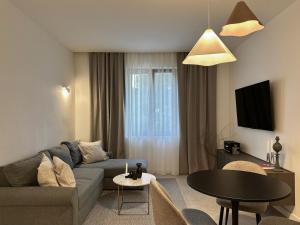 a living room with a couch and a table at Miol apartment in Kaštela