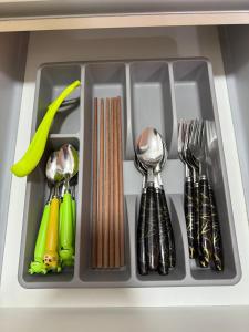 a tray filled with utensils in a drawer at Almas Suites, Puteri Harbour SI home in Iskandar Puteri +12 photos