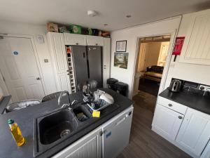 a kitchen with a sink and a counter top at Shared Home - Self Check-In - Resident Cat in Hatfield