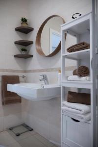a white bathroom with a sink and a mirror at Golden Harbour - 2 Bedrooms, 2 Bathrooms in Il-Gżira