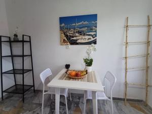 a dining room table with a bowl of fruit on it at Kalimera apartments in Marathias +23 photos