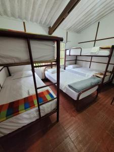 a room with three bunk beds in a room at Casa quinta del 11 in La Vega