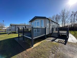 a tiny house in a yard with a fence at Luxury 8 Berth Caravan At Butlins Skegness in Skegness
