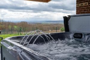a tub filled with water with water at Villa privative Beauraing L'écrin in Beauraing