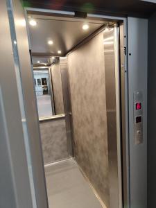 a sliding glass door with a mirror in a elevator at Αnchor Suites in Thessaloniki