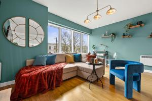 a living room with a couch and a table at Dapper Suite in bustling Holloway, Islington by Gold Stays in London