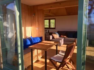 a living room with a table and a couch at Seaview Studio in Forrabury