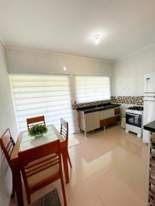 Una cocina con una mesa y sillas en una habitación. en Recanto da Serra, en Serra Negra