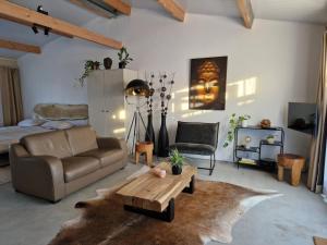 a living room with a couch and a coffee table at De Wilde Tuin - Studio Lotus in Moergestel