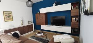 a living room with a couch and a tv at Wind Rose Duplex in Gran Tarajal