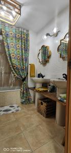 a bathroom with a sink and a shower curtain at Wind Rose Duplex in Gran Tarajal