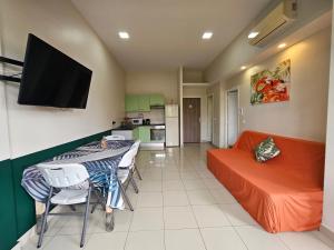 a living room with a table and a couch at F2 PAPEETE CITY CENTER in Papeete