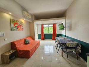 a living room with a table and a bed and a dining room at F2 PAPEETE CITY CENTER in Papeete