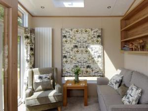 a living room with a couch and two chairs and a table at Rockville Lodge - Uk2503 in Bempton