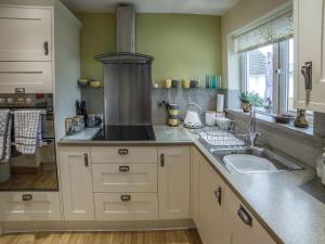 a kitchen with a sink and a stove at Briargarth in Keswick