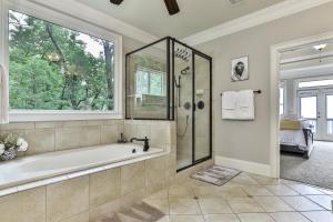 a large bathroom with a tub and a window at Endless Sky Lodge - Luxury Big Canoe Cabin with Hot Tub in Jasper +93 photos
