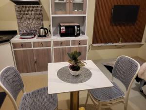 a table with a potted plant on it in a kitchen at Cozy City Escape - Avida Aspira Tower 1, CDO in Cagayan de Oro