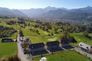 an aerial view of a resort with mountains in the background at Charmante maison d'hôtes de vacances - HI PYRENEES - Jardin privé de 4000 m2 face au Pic du Midi in Bagnères-de-Bigorre
