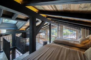 a room with a bed in the middle of a house at Les Chalets de La Clusaz - Appartement le Renne in La Clusaz