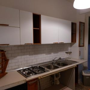 a kitchen with a sink and a stove at Camera "La Rosa" in Pistoia