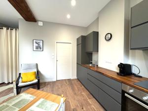 a kitchen with a table and a counter top at Appartement agréable proche gare in Vienne