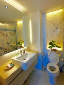 a bathroom with a sink and a toilet at Pattaya Atlantis Resort Sea View Apartments in Jomtien Beach