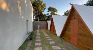 a courtyard with two buildings and a fence at Chalé com ventilador in Itacaré +8 photos