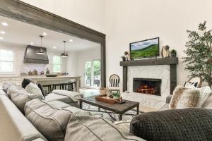 a living room with a couch and a fireplace at Robins Nest at Big Canoe - Big Canoe, GA - Enjoy Peaceful Forest Views, Rack Up a Game of Pool, and Enjoy Game Nights in the Gam in Jasper