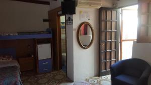 a room with a mirror and a room with a bed at Aquilone Residence in Stromboli