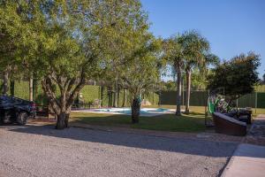 a park with a playground with trees at Viageiro Casa Hotel in Pelotas
