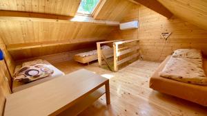 a room with a bed and bunk beds in a cabin at "OhMazury" ogród i winnica in Giżycko