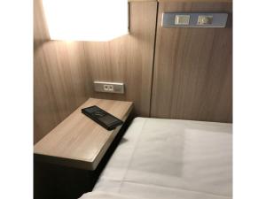 a small room with a bed and a table at Garden Hotel Shizuoka - Vacation STAY 45849v in Shizuoka +35 photos