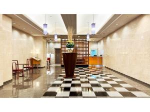 a lobby with a checkered floor and a plant at Garden Hotel Shizuoka - Vacation STAY 45849v in Shizuoka