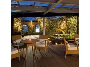 a patio with a table and chairs and lights at Garden Hotel Shizuoka - Vacation STAY 45849v in Shizuoka