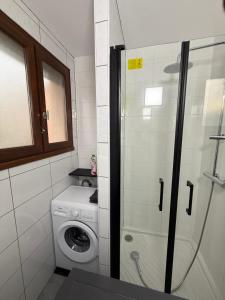 a bathroom with a washing machine and a washer at MonnaLisa in Périgueux +23 photos