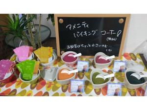 a table with bowls of food and a chalkboard at Hotel M&K Ishinomaki - Vacation STAY 54465v in Ishinomaki