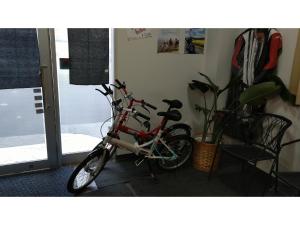 a red bike parked in a room next to a plant at Hotel M&K Ishinomaki - Vacation STAY 54465v in Ishinomaki