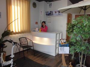 a woman sitting at a counter in a salon at Hotel M&K Ishinomaki - Vacation STAY 54465v in Ishinomaki