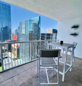 Una mesa y sillas en un balcón con vista a la ciudad. en Brickell Center w/City & Bay View + FREE Parking!, en Miami