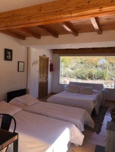 En eller flere senge i et værelse på Odella Casas de Montaña en Vallecitos