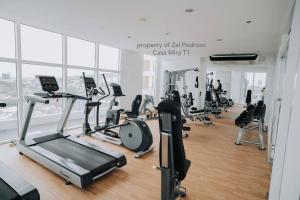 a gym with treadmills and ellipticals in a building at Minimalist Haven, Maximum Cebu Fun! in Cebu City +5 photos