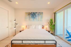 a bedroom with a bed and a large window at Surfside Sanctuary in South Padre Island +20 photos