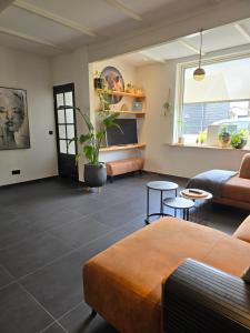 a living room with a couch and a table at Tip Top Vakantie Huis in Vlissingen