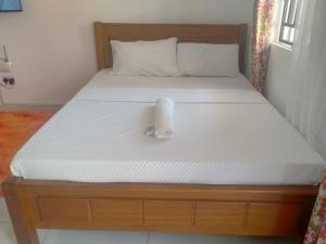 a roll of toilet paper sitting on top of a bed at R&Joy Stays in Mtwapa
