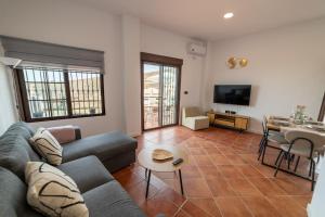 a living room with a couch and a table at Apartamento Monte Mar 2 in Haza del Trigo
