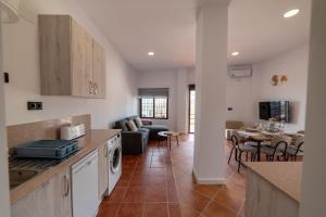 a kitchen and living room with a couch and a table at Apartamento Monte Mar 2 in Haza del Trigo