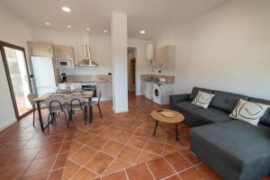 a living room with a couch and a table at Apartamento Monte Mar 2 in Haza del Trigo +14 photos