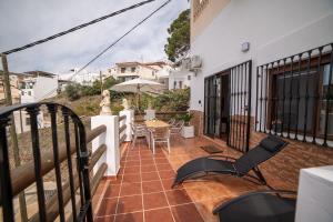 a balcony of a house with a table and chairs at Apartamento Monte Mar 2 in Haza del Trigo