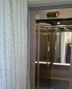 a reflection of a refrigerator in a mirror at Hotel Franca in Riolo Terme